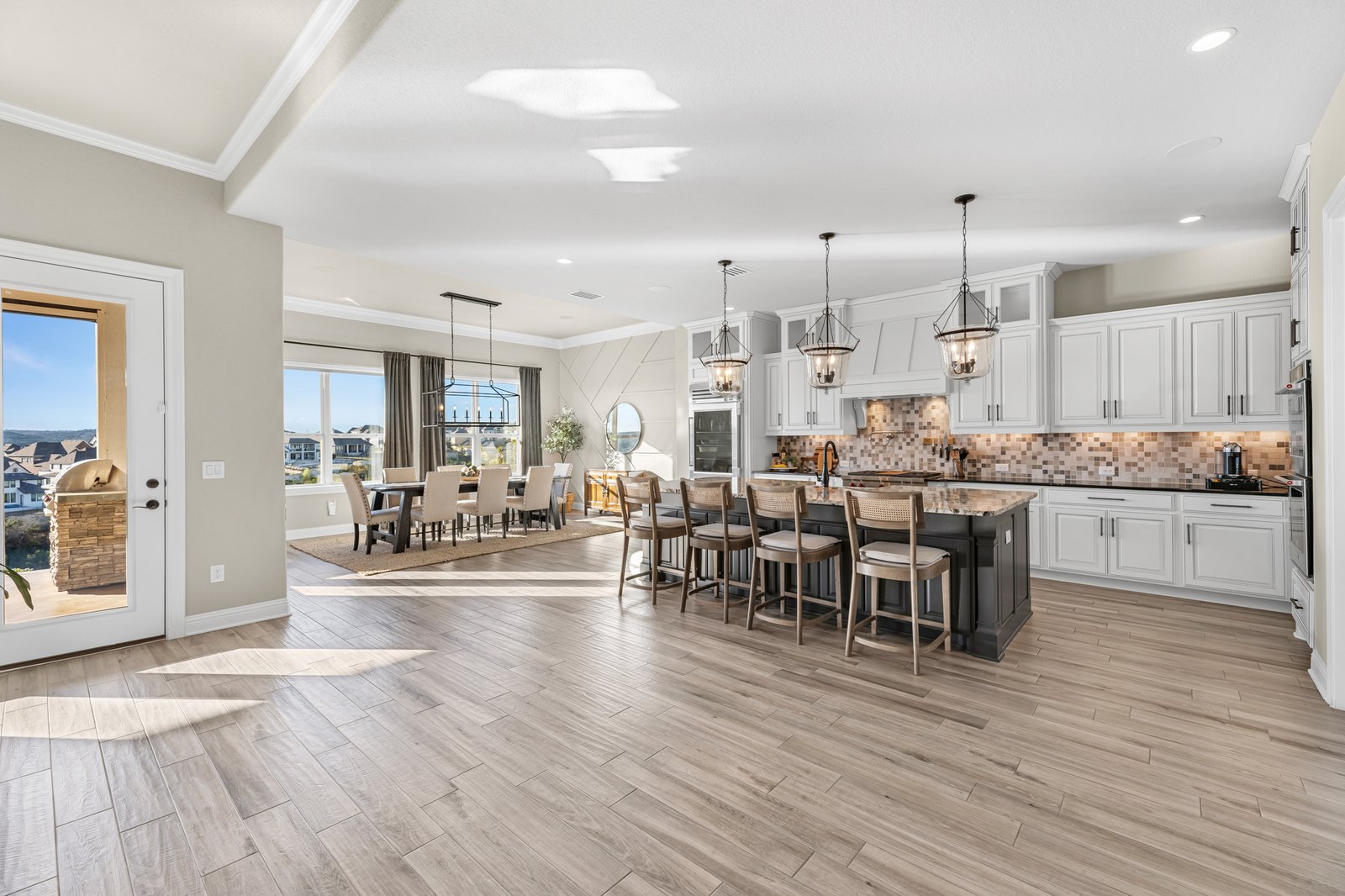 Open kitchen and dining area with a long island and pendant lights