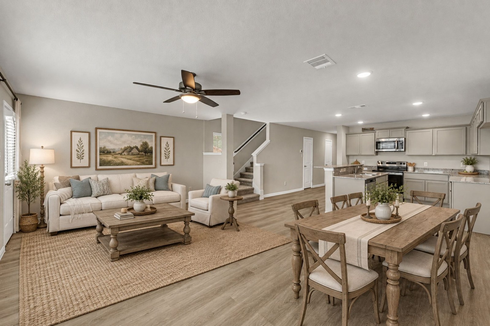 Virtually staged open living and dining room with a farmhouse table